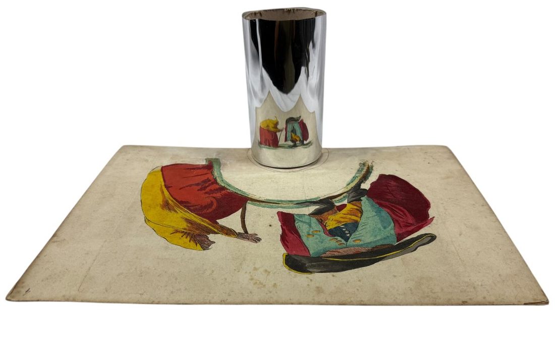 Stand a polished cylinder on the marked circle and the reflection reassembles the scene.
